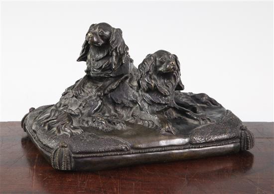 A late 19th / early 20th century patinated bronze group modelled as two spaniels, 8.5in.